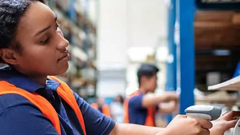 Logistics worker in warehouse with digital tablet